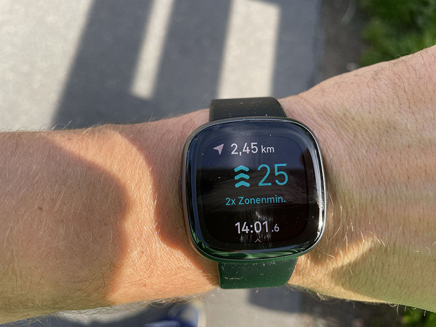 Man sieht die Fitbit mit GPS am Arm. 